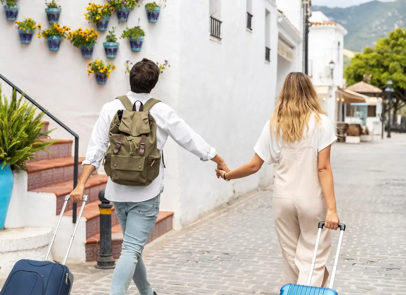 Medium shot of a couple with luggage.